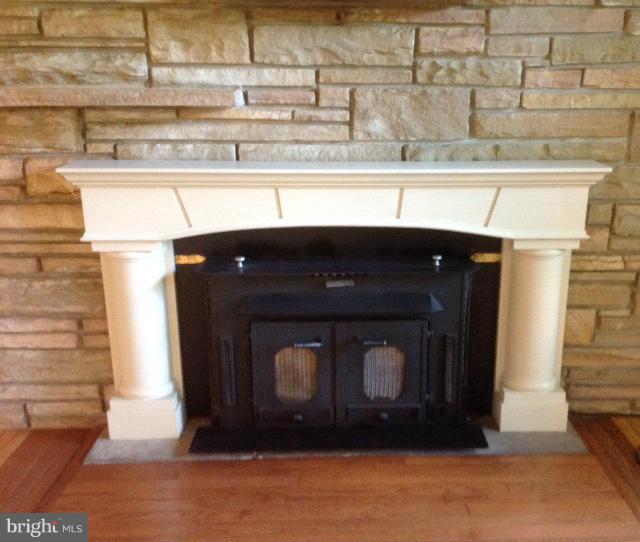9403 Brandywine Road Clinton, MD 20735 - Photo 4 of 30 Mantled Fireplace On Stone Wall - Stove Insert