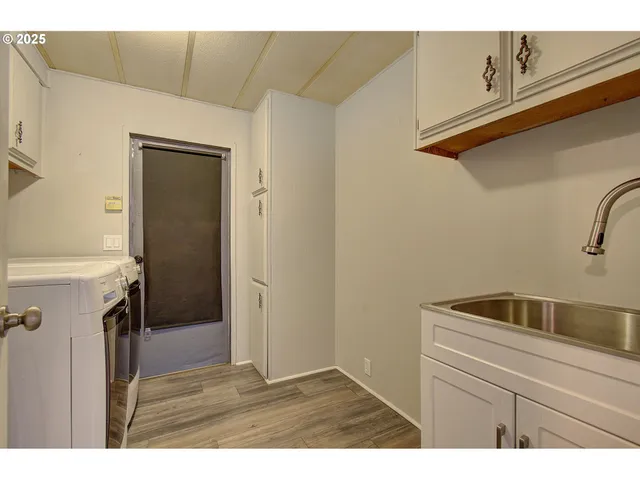 a kitchen with a refrigerator and a sink