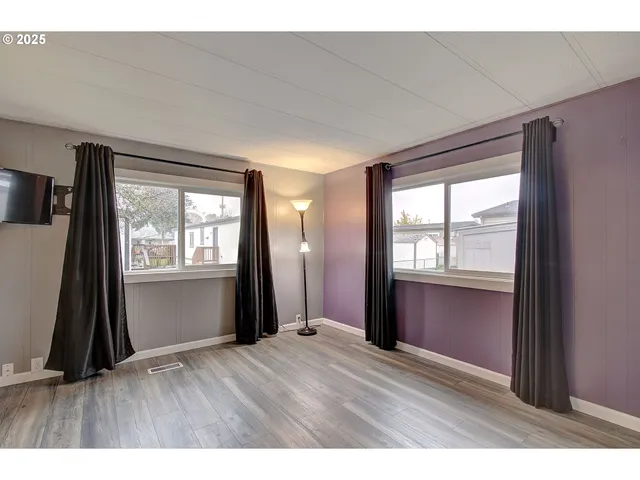 a room that has a bed mirror and window