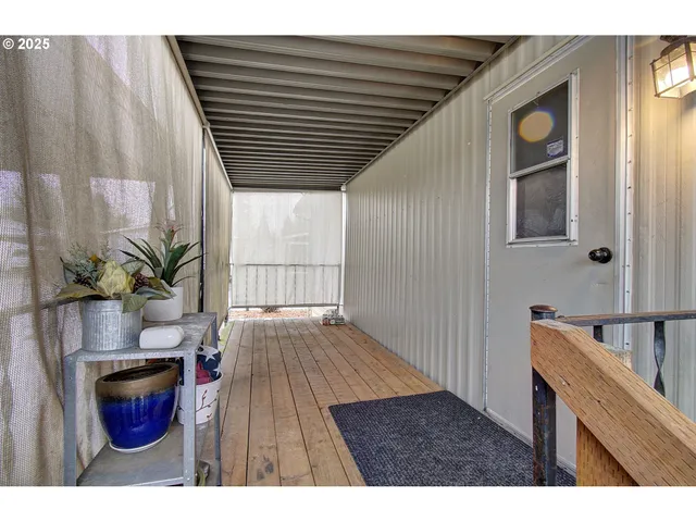 a hallway with wooden floors and furniture