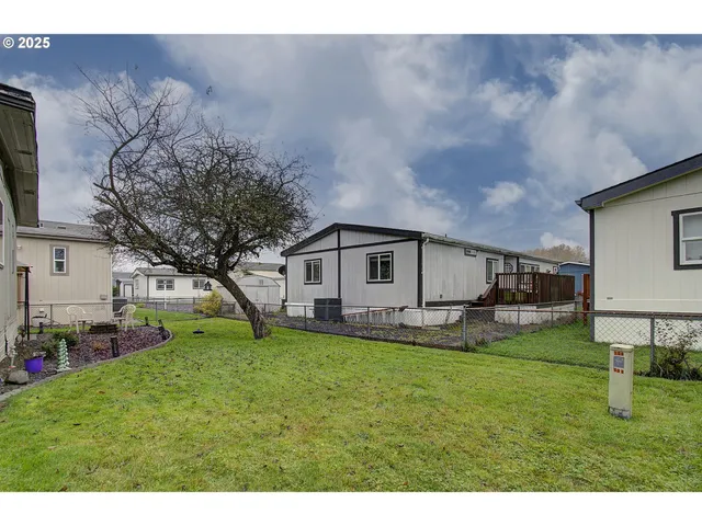 a backyard of a house with table and chairs