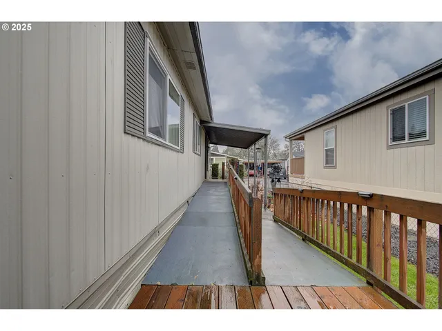 a view of a hallway with wooden floor and stairs