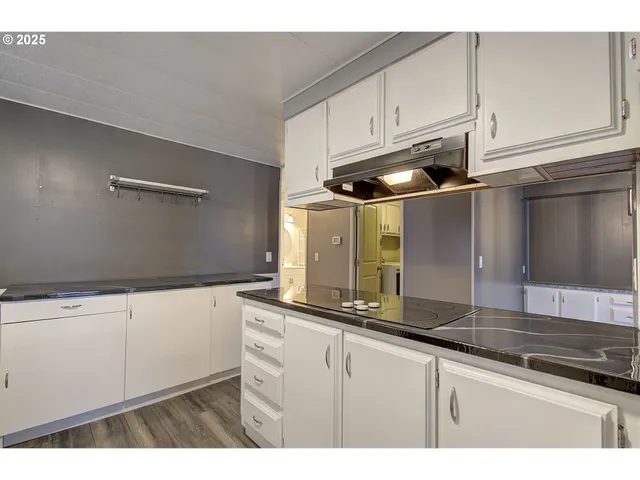 a kitchen with stainless steel appliances granite countertop a sink and a stove