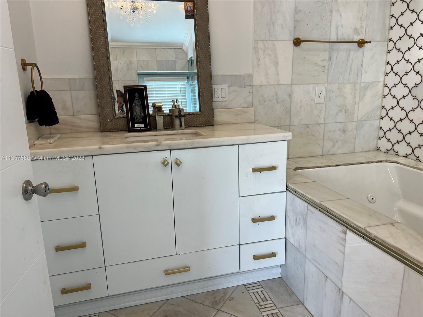 The Hammocks Miami, FL 33186 - Photo 25 of 28 a bathroom with a granite countertop sink and washing machine