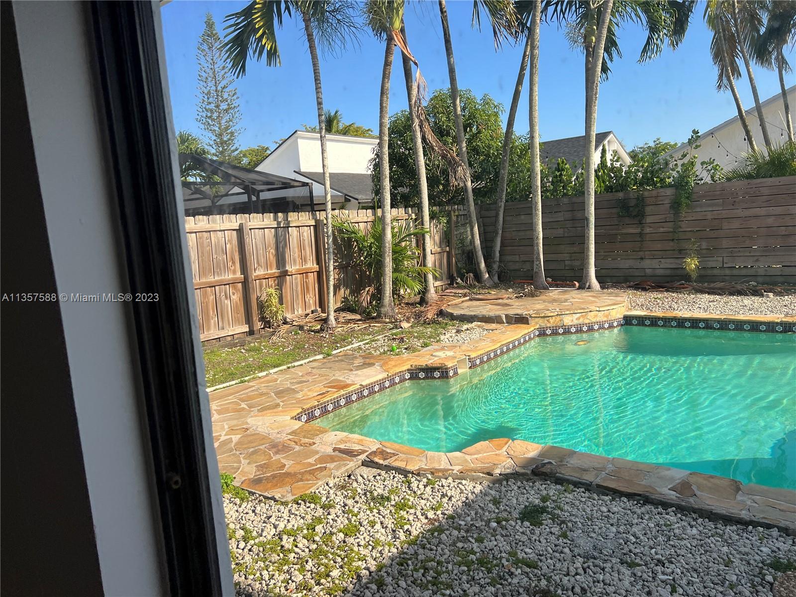 The Hammocks Miami, FL 33186 - Photo 28 of 28 a view of a house with a swimming pool and porch with furniture