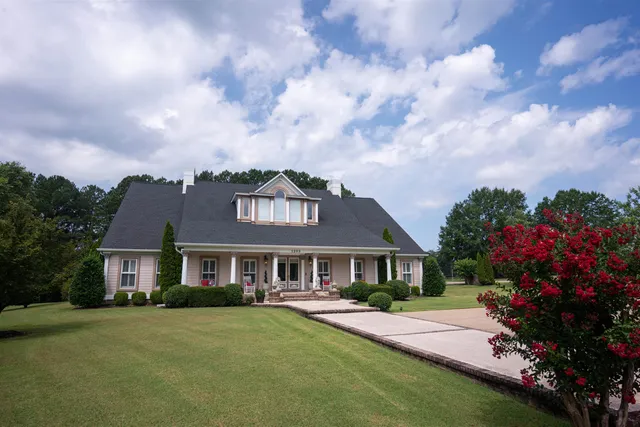 a front view of a house with a garden