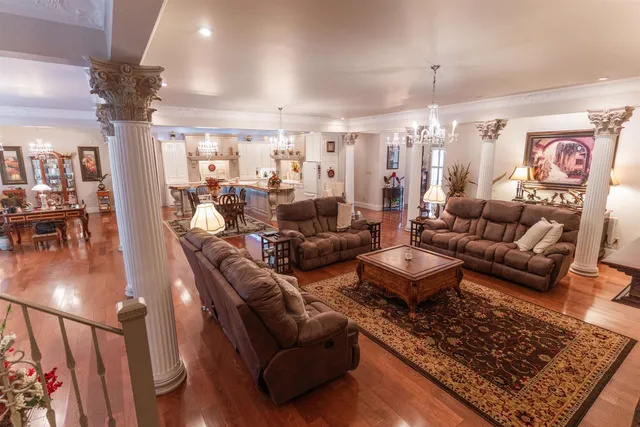 a living room with furniture and a chandelier