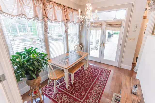 a view of a room with furniture and wooden floor