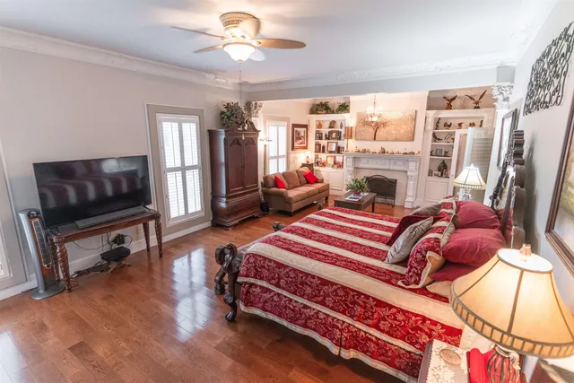a bedroom with furniture and a flat screen tv
