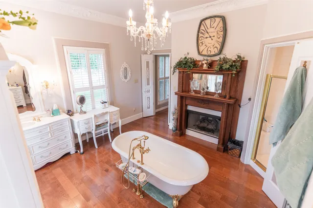 a living room with furniture a clock and a fireplace