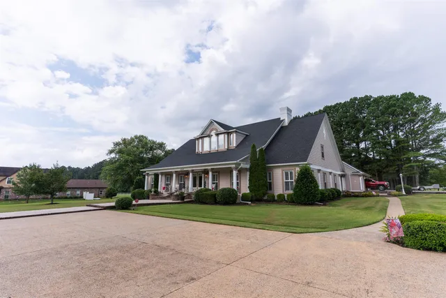 a view of house with yard and green space