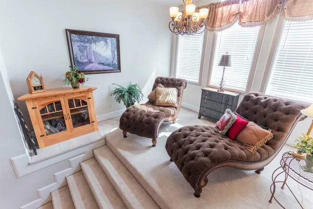 a living room with furniture and stairs