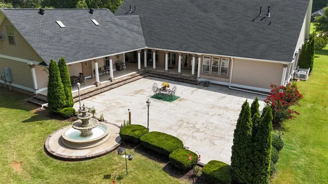 a view of a house with a yard and sitting area