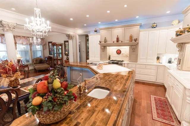 a large white kitchen with a large window