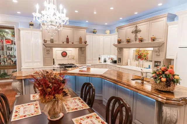 a kitchen with stainless steel appliances granite countertop a sink and a white cabinets