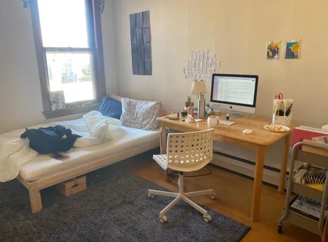 a living room with furniture a window and a table