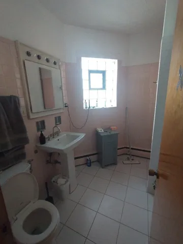 a bathroom with a sink toilet and mirror