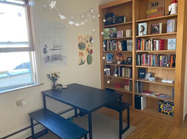 a view of a workspace with furniture and window