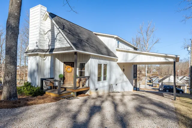 a view of a house with large windows and plants