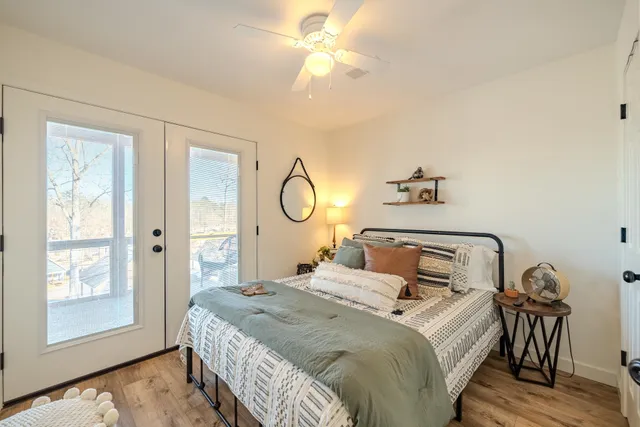 a bedroom with a bed and a chandelier