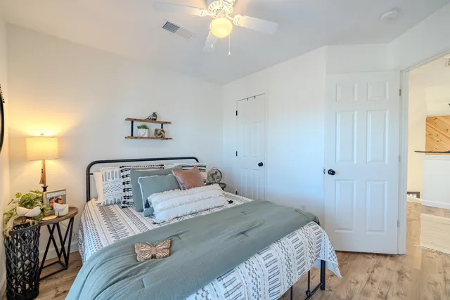 a bedroom with a large bed and a chandelier