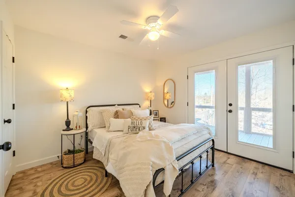 a bedroom with a bed and a chandelier