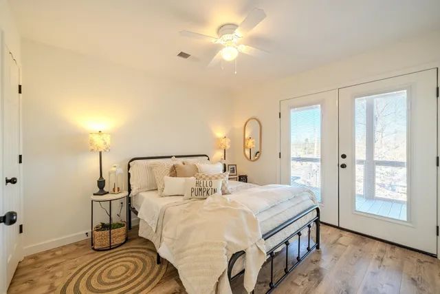 a bedroom with a bed and a chandelier