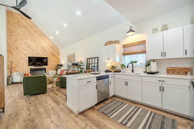 a kitchen with stainless steel appliances a refrigerator sink and microwave