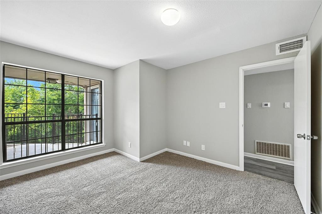 8545 Midpark Road, Unit 66 Dallas, TX 75240 - Photo 12 of 27 wooden floor and windows in an empty room