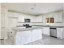 a kitchen with kitchen island a sink stainless steel appliances and cabinets
