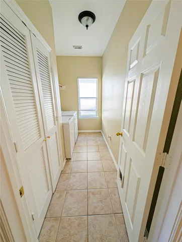 a view of a patio with a table and chairs under an umbrella