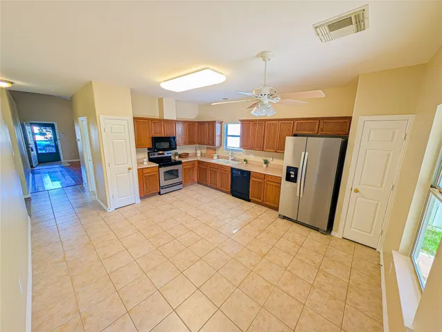 a kitchen with a sink a stove and cabinets