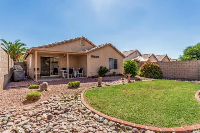 a view of a house with backyard porch and sitting area