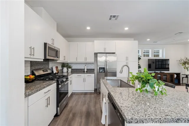 a living room with furniture a table and a potted plant