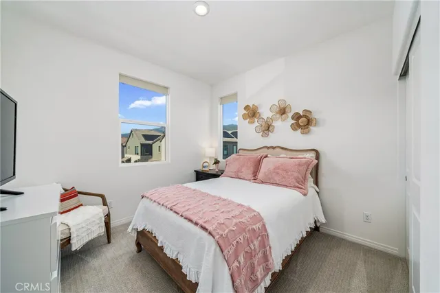 a bedroom with two beds and a flat screen tv