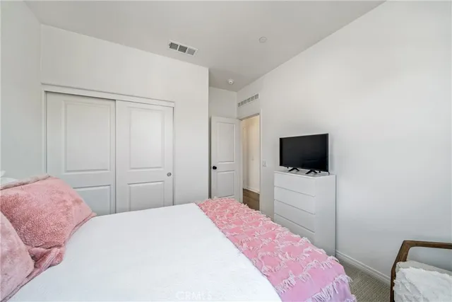 a bedroom with a bed and a night stand