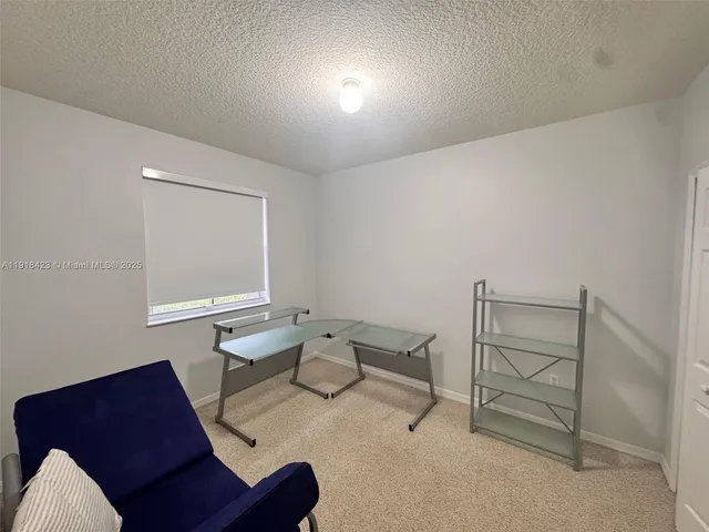 a reading room with furniture and a window