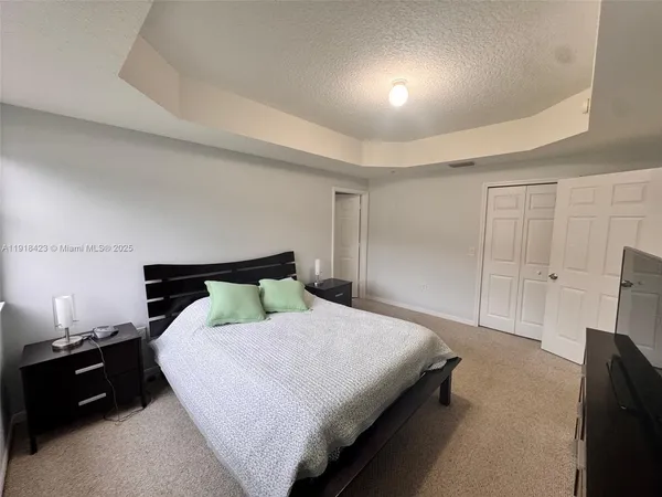 a bedroom with a bed and walk in closet