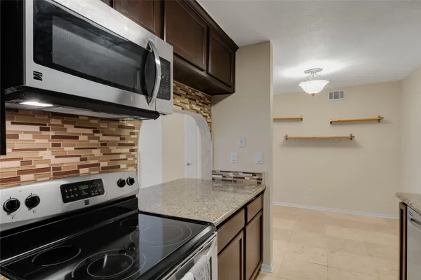a kitchen with a stove and a microwave