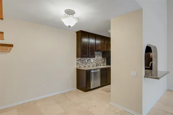 a view of kitchen with granite countertop cabinets and stainless steel appliances