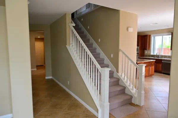 a view of entryway and hall with wooden floor