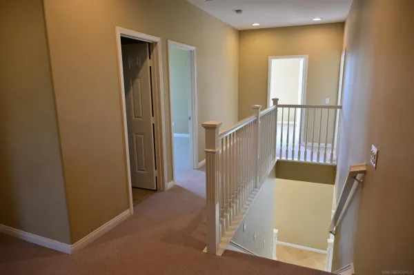 an entryway door with wooden floor