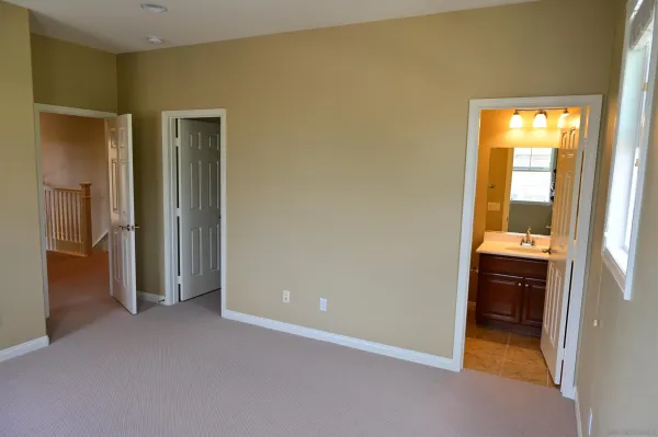 an empty room with a bathroom and a sink