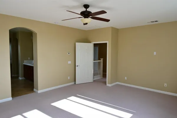 a view of empty room with ceiling fan