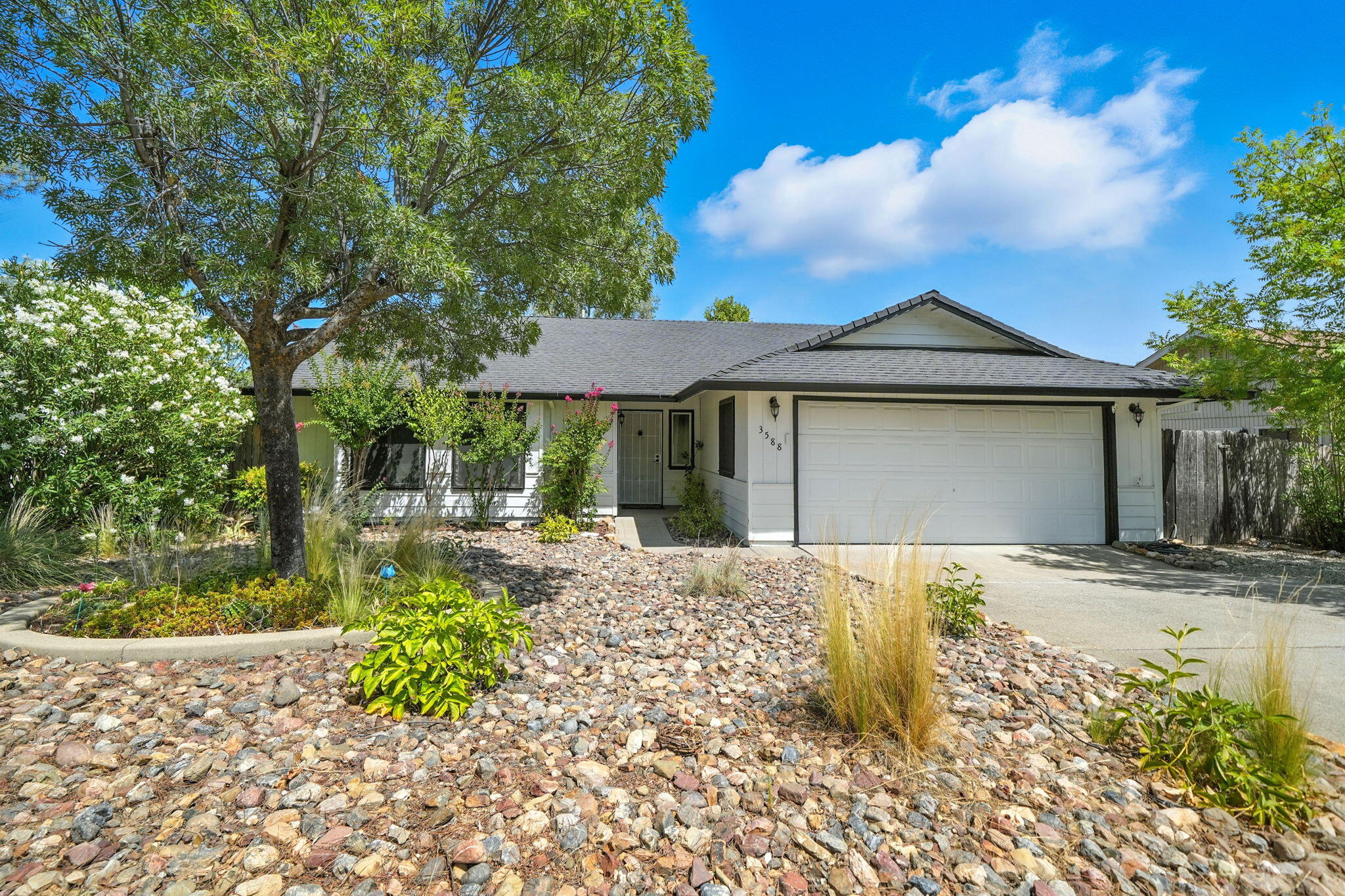 3588 Magnums Way Redding, CA 96003 - Photo 1 of 35 a front view of a house with a garden