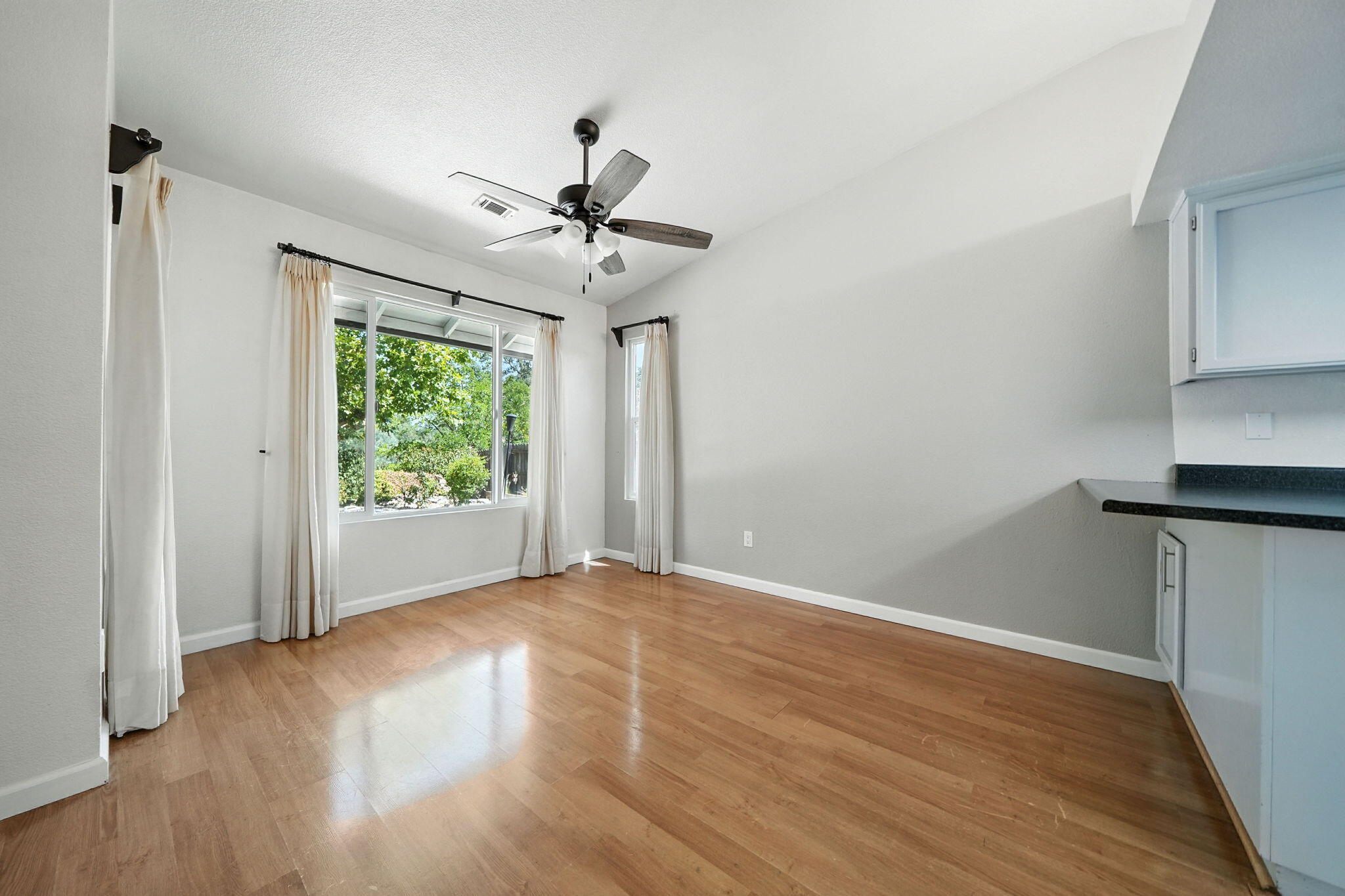 3588 Magnums Way Redding, CA 96003 - Photo 11 of 35 a view of empty room with wooden floor and fan