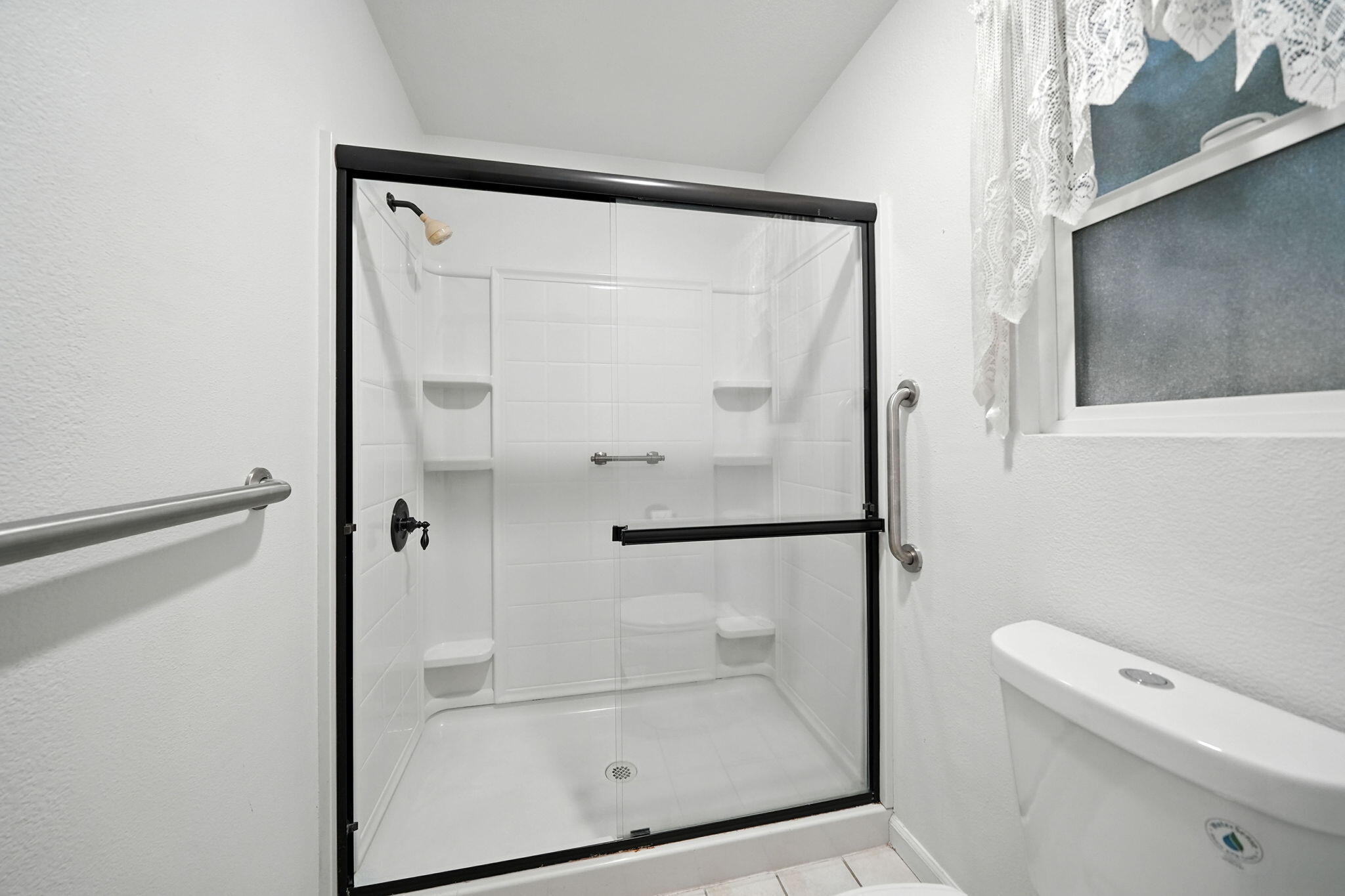 3588 Magnums Way Redding, CA 96003 - Photo 16 of 35 a bathroom with a glass shower door