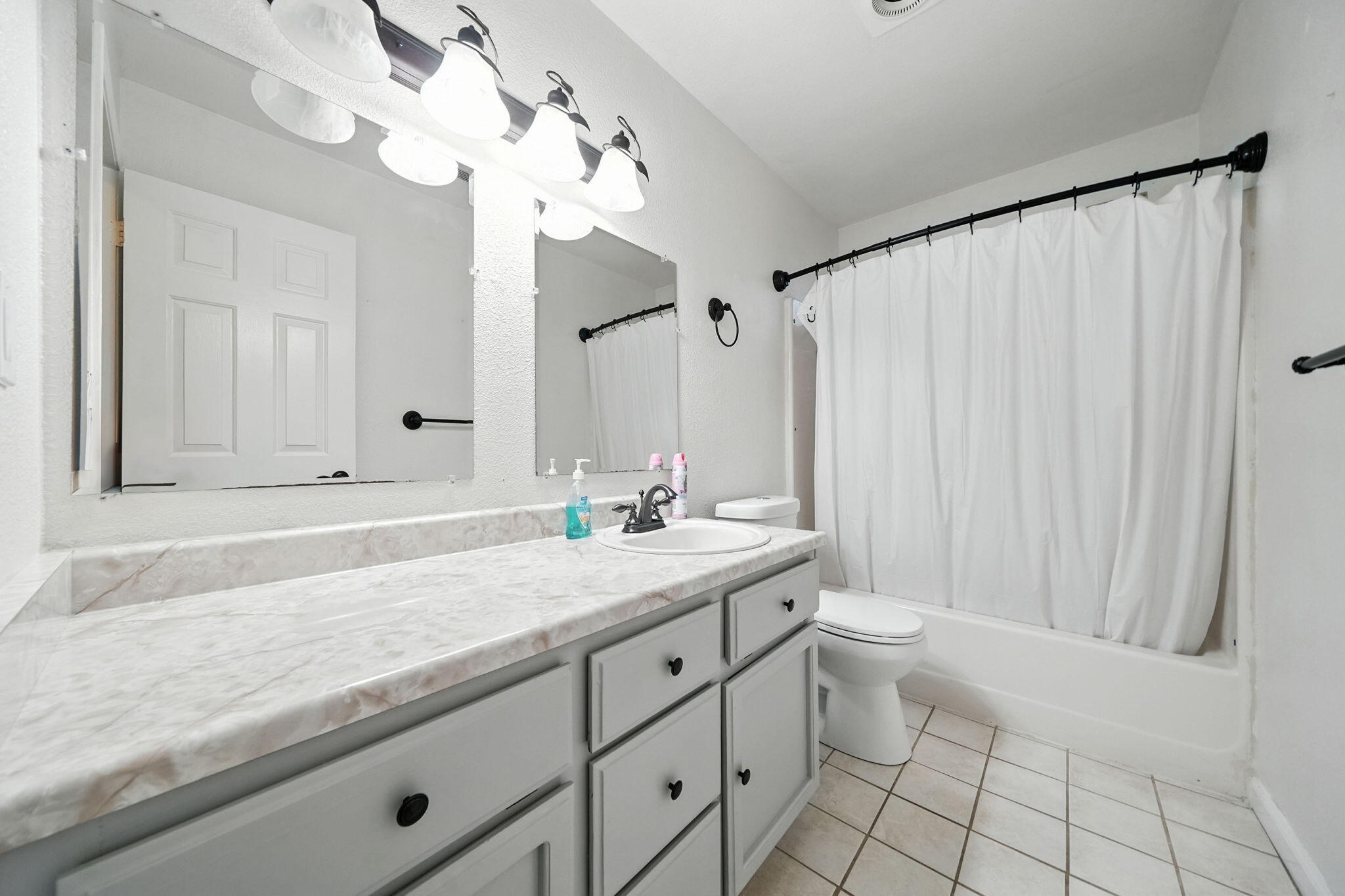3588 Magnums Way Redding, CA 96003 - Photo 19 of 35 a bathroom with a granite countertop sink a toilet and a mirror
