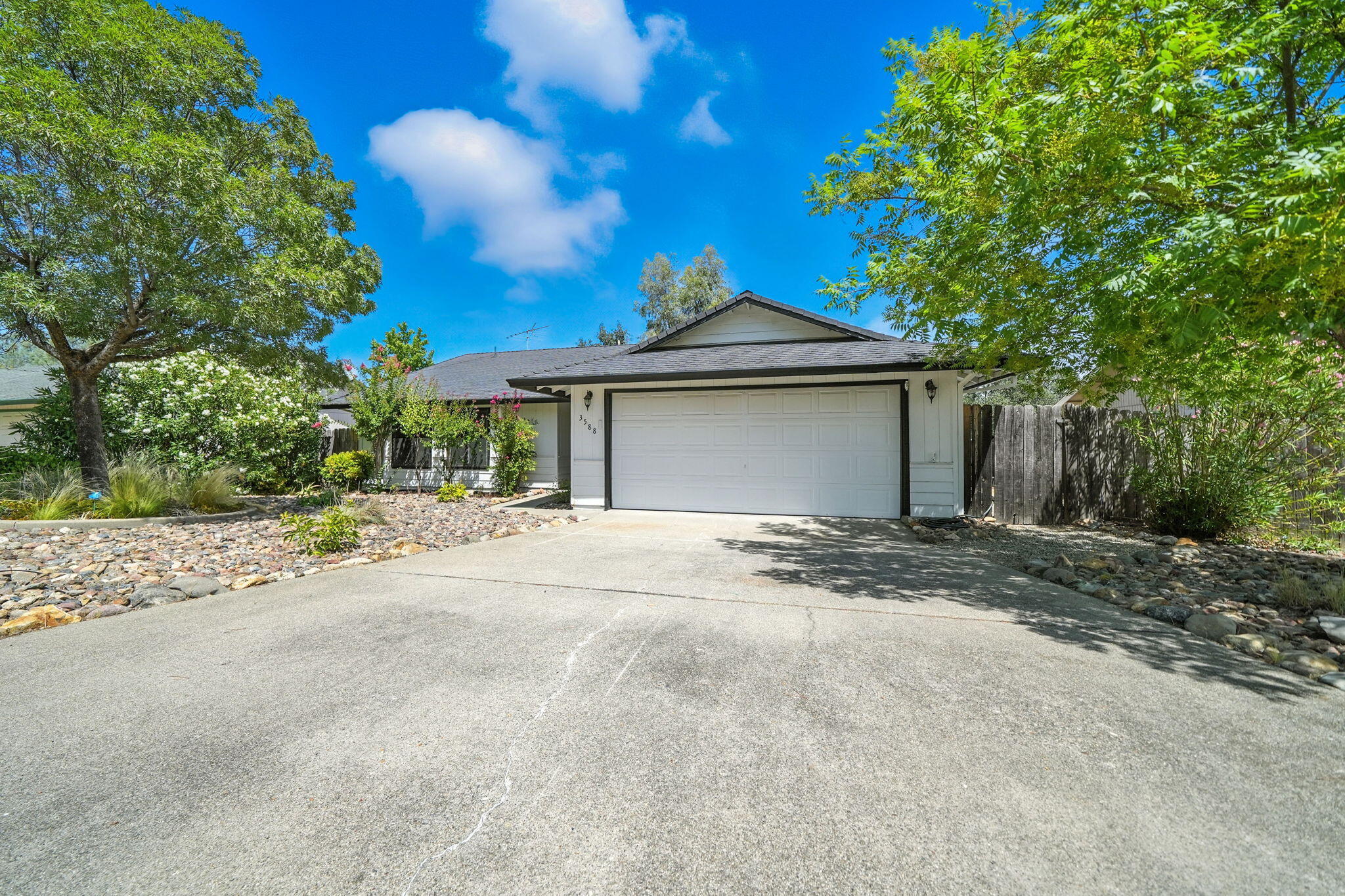 3588 Magnums Way Redding, CA 96003 - Photo 29 of 35 a front view of a house with a garden