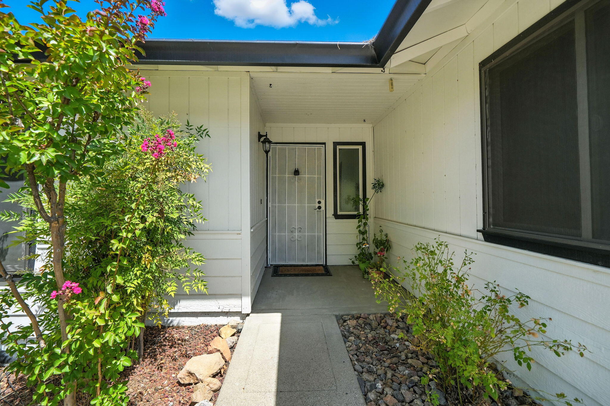 3588 Magnums Way Redding, CA 96003 - Photo 3 of 35 a couple of flowers in front of a door
